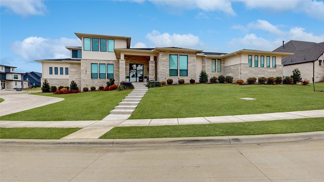 prairie-style house with stone siding, stucco siding, and a front lawn