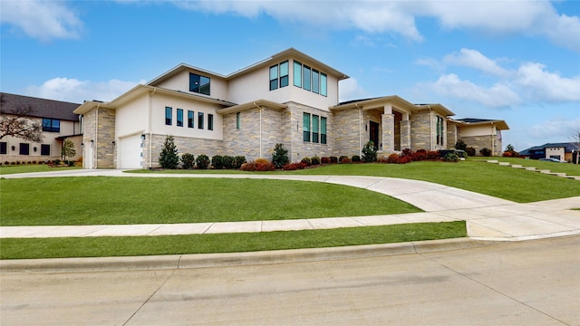 view of front facade with a front yard, stone siding, driveway, and stucco siding