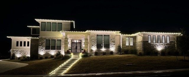 mediterranean / spanish house featuring stone siding