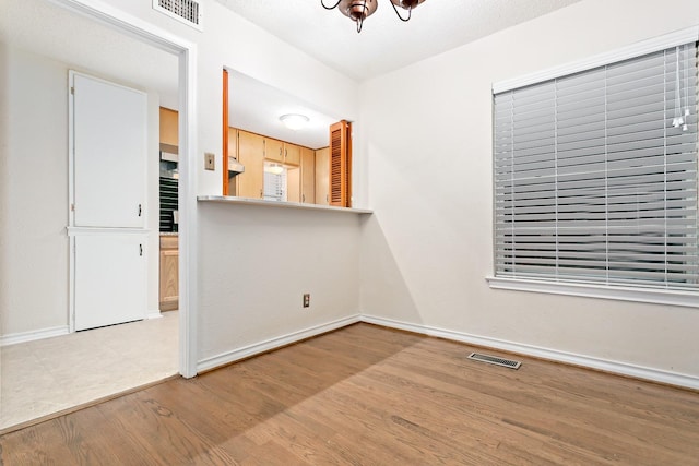 unfurnished room with wood-type flooring