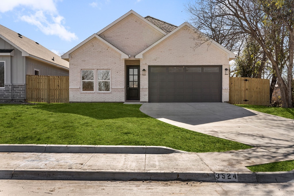 ranch-style home with a garage and a front yard