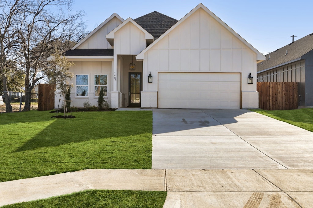 view of front of home featuring a garage and a front lawn