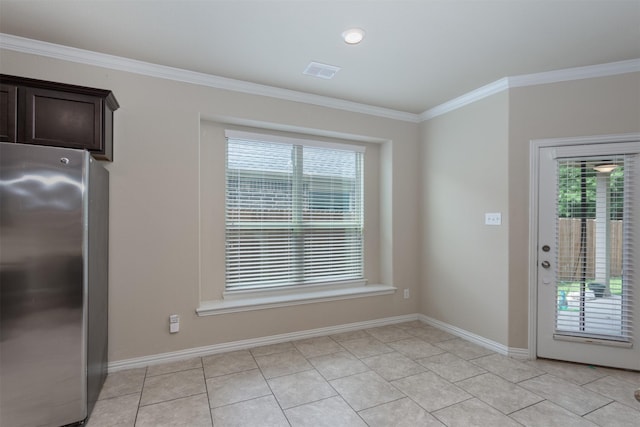 unfurnished dining area with light tile patterned floors, crown molding, and a healthy amount of sunlight