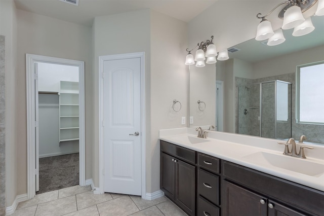 bathroom featuring a shower with door, vanity, tile patterned floors, and a chandelier