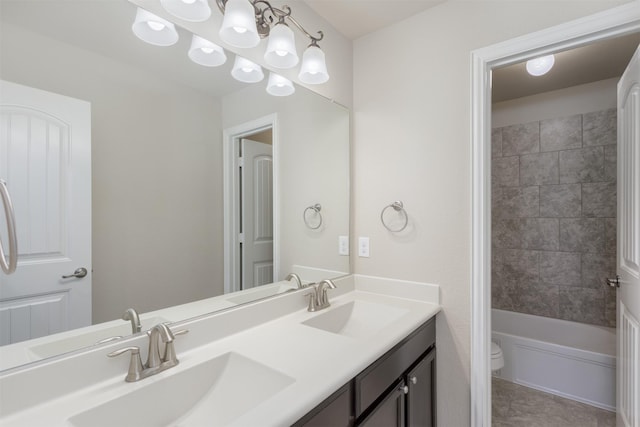 bathroom with a notable chandelier, vanity, tile patterned floors, and toilet