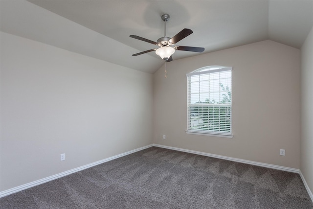 carpeted empty room with ceiling fan and vaulted ceiling