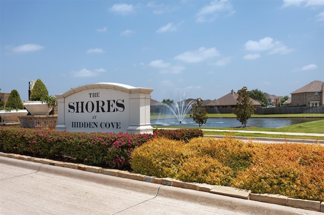 community / neighborhood sign with a water view