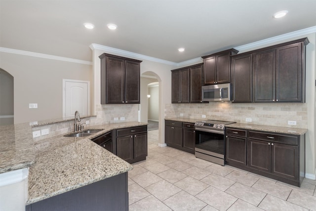 kitchen featuring sink, crown molding, appliances with stainless steel finishes, light stone countertops, and decorative backsplash