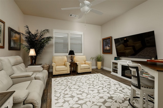 living room featuring dark hardwood / wood-style floors and ceiling fan