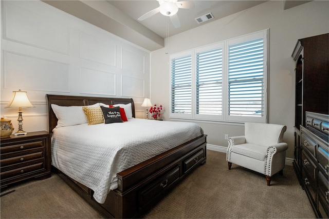 bedroom featuring ceiling fan and dark carpet