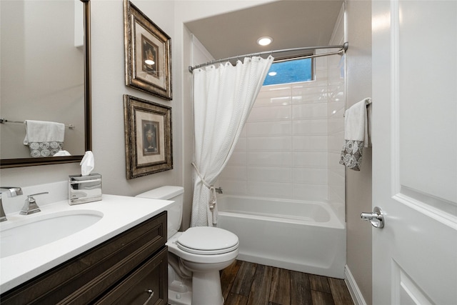 full bathroom with vanity, hardwood / wood-style floors, shower / bath combo, and toilet