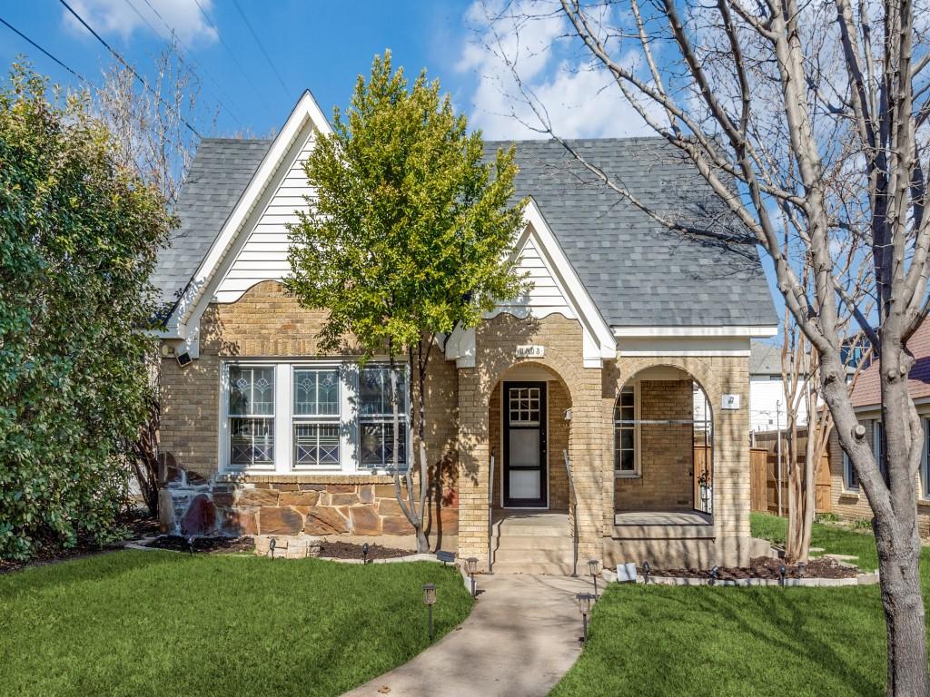 tudor home featuring a porch and a front yard