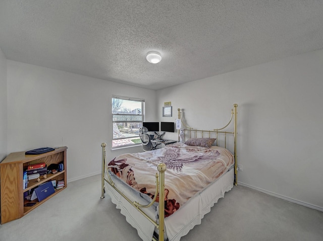 carpeted bedroom featuring baseboards and a textured ceiling