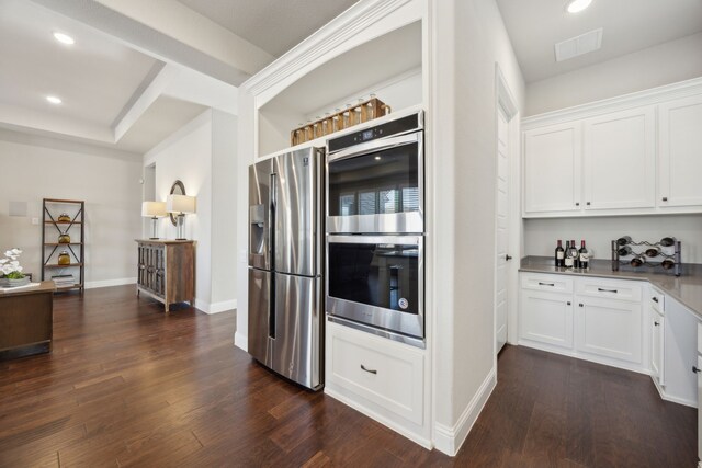 kitchen with stainless steel appliances, dark hardwood / wood-style floors, and white cabinets