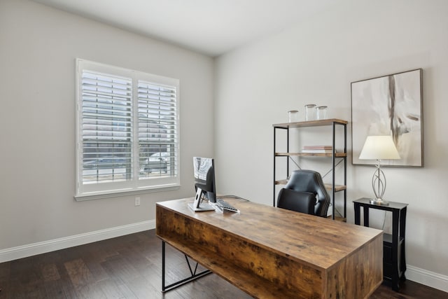 office with plenty of natural light and dark hardwood / wood-style flooring