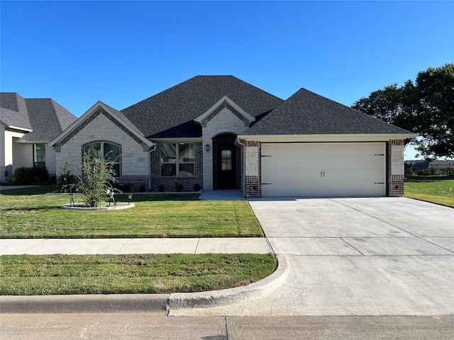 view of front of property with a garage and a front lawn