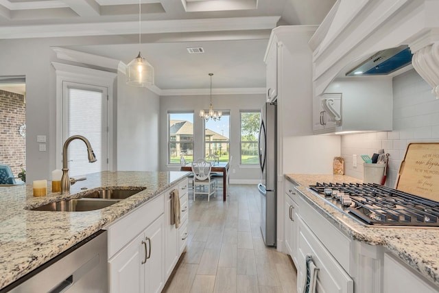 kitchen featuring sink, hanging light fixtures, stainless steel appliances, tasteful backsplash, and white cabinets