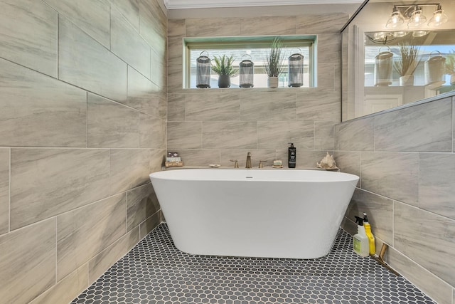 bathroom with tile patterned floors, a bath, and tile walls