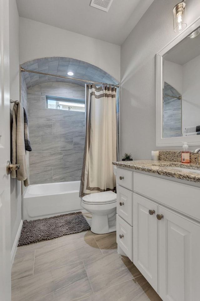 full bathroom featuring vanity, toilet, and shower / bathtub combination with curtain