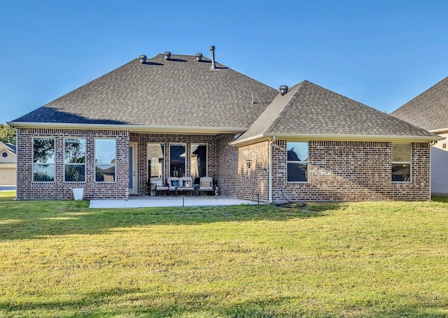 back of house featuring a lawn and a patio