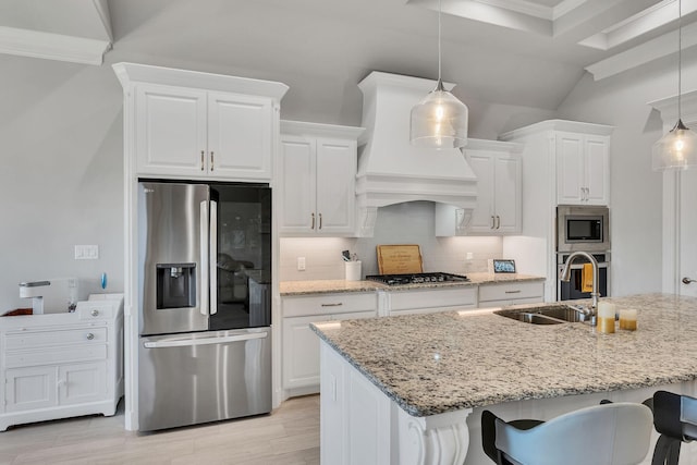 kitchen with backsplash, decorative light fixtures, white cabinets, and appliances with stainless steel finishes