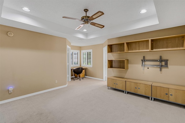 mudroom with light colored carpet, a raised ceiling, and ceiling fan