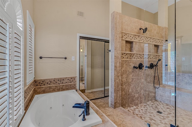 bathroom featuring independent shower and bath and tile patterned flooring