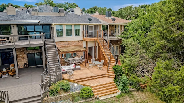 back of house with central AC unit, an outdoor hangout area, and a deck