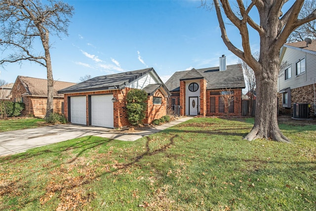 view of front of home with a front yard and central air condition unit