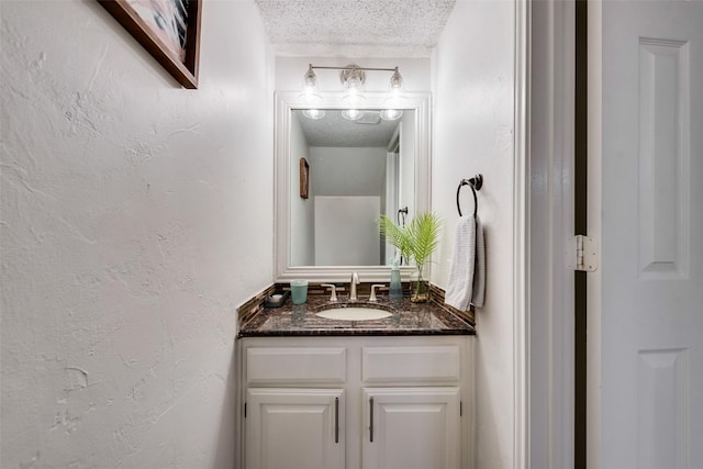 bathroom with vanity and a textured ceiling