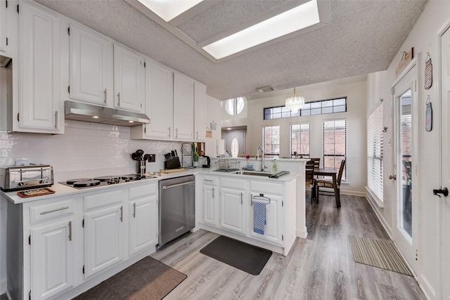 kitchen with kitchen peninsula, hanging light fixtures, dishwasher, and white cabinets