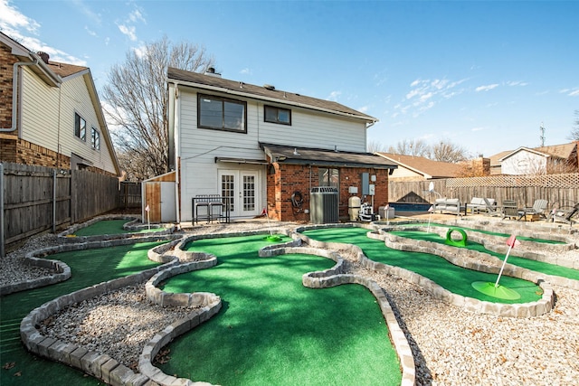 rear view of house featuring a patio area, french doors, and central air condition unit