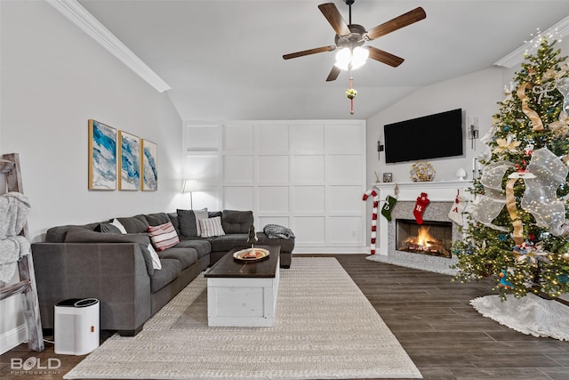 living room featuring vaulted ceiling, dark hardwood / wood-style floors, ceiling fan, and crown molding