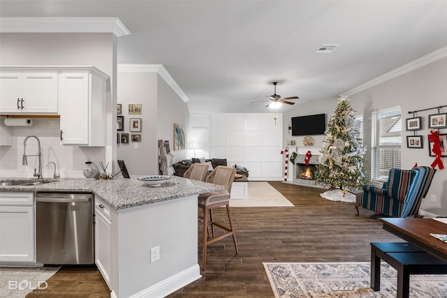 kitchen with dark wood-type flooring, sink, white cabinetry, dishwasher, and light stone countertops