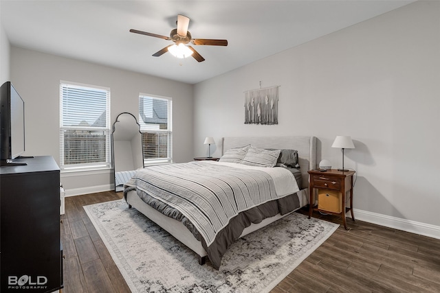 bedroom with ceiling fan and dark hardwood / wood-style floors