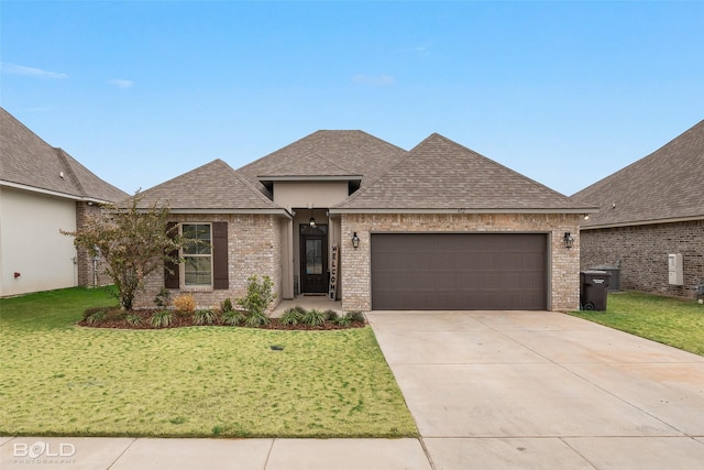 view of front of property featuring a garage and a front yard