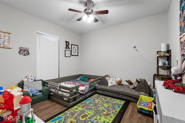 recreation room featuring dark wood-type flooring and ceiling fan