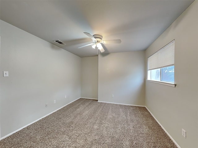 carpeted spare room with ceiling fan