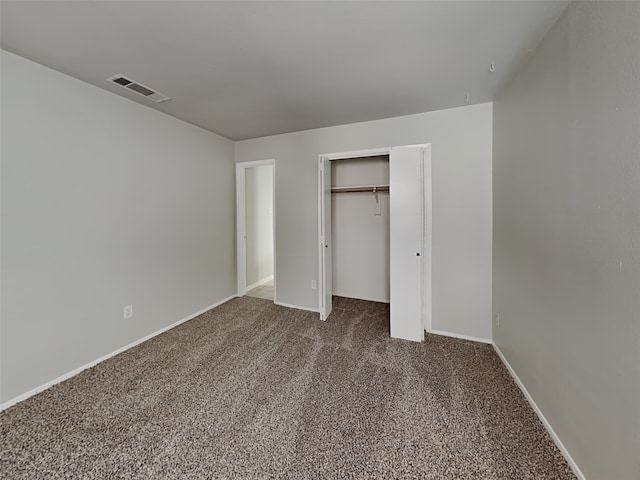 unfurnished bedroom featuring carpet floors and a closet