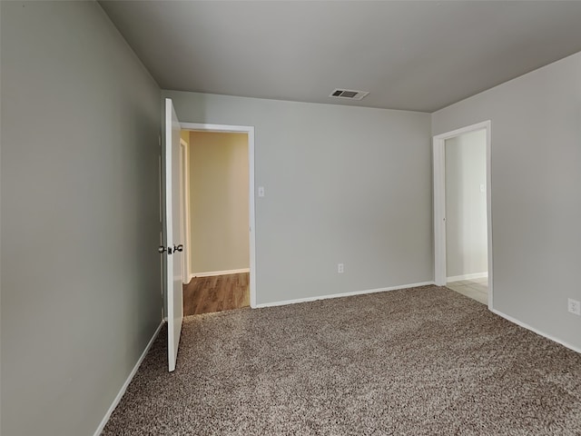 unfurnished room featuring light carpet