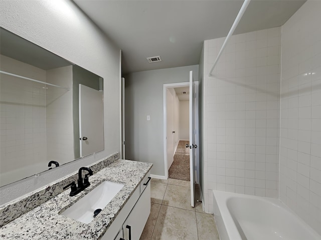 bathroom with vanity, tile patterned floors, and tiled shower / bath