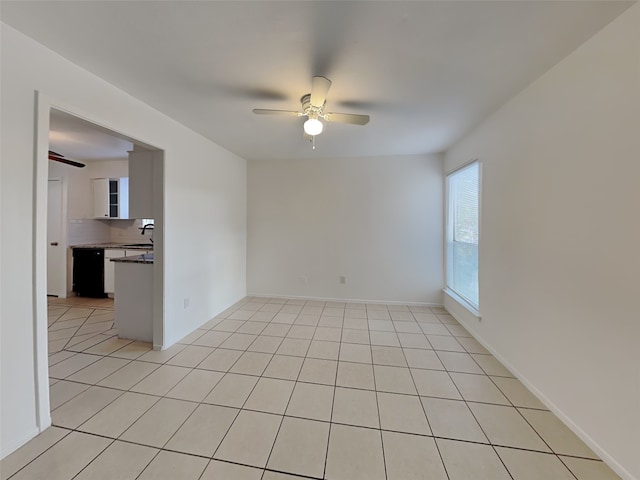 tiled empty room with ceiling fan and sink