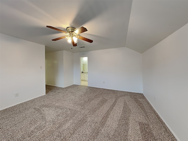 spare room featuring ceiling fan, lofted ceiling, and carpet flooring