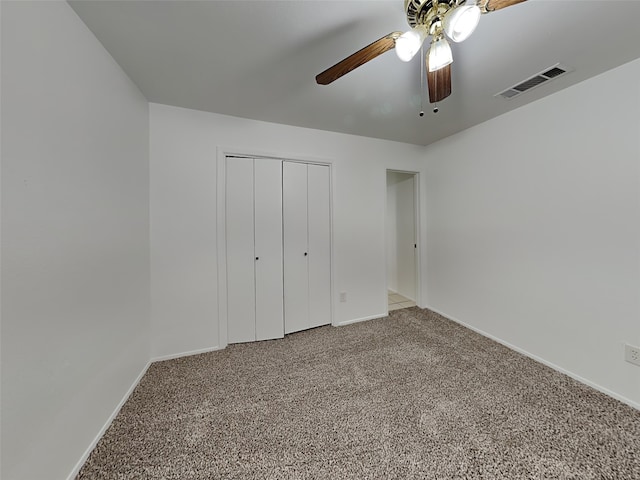 unfurnished bedroom with ceiling fan, carpet floors, and a closet