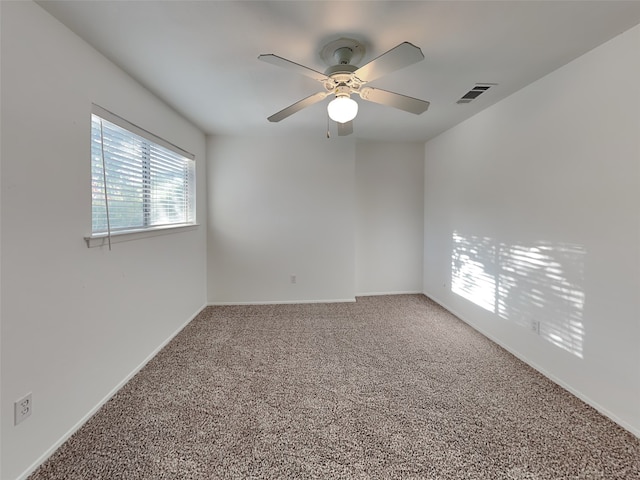 carpeted spare room with ceiling fan