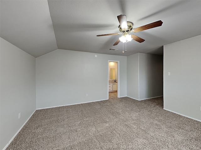 carpeted empty room featuring vaulted ceiling and ceiling fan