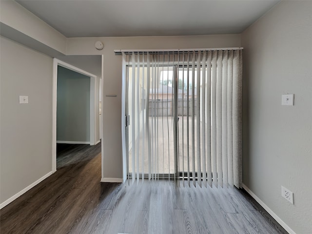 unfurnished room with hardwood / wood-style flooring