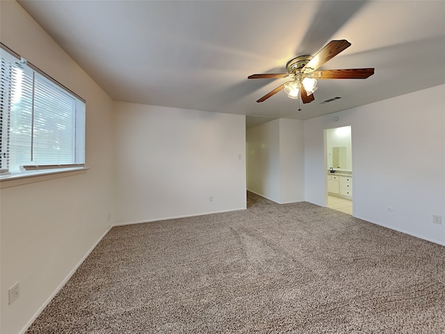 unfurnished room with ceiling fan and carpet floors