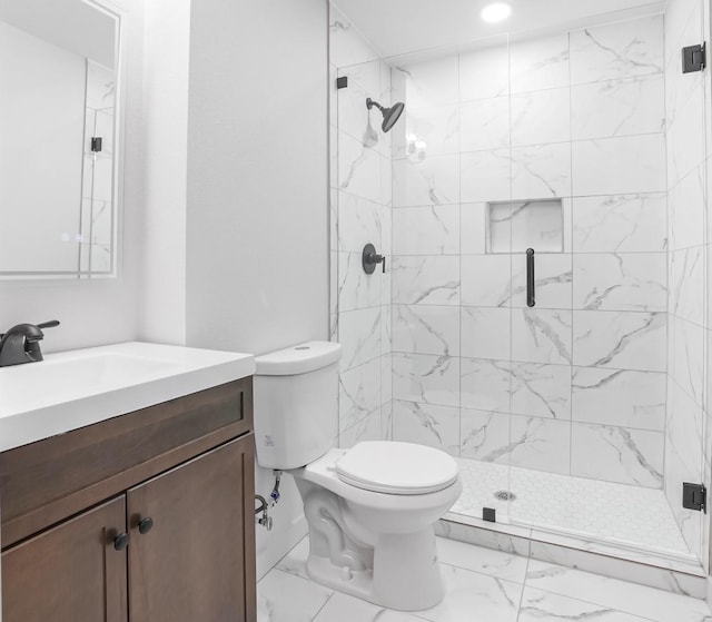 bathroom with vanity, toilet, and an enclosed shower