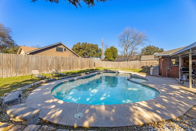 view of pool featuring grilling area and a patio area